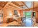 Serene main bedroom with a four-poster bed, wood floors, and a private balcony with a view of nature at 169 Country Brooke Lane Ln, Roxboro, NC 27574