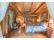 Warm main bedroom with wood walls, a four-poster bed, and large windows with natural light at 169 Country Brooke Lane Ln, Roxboro, NC 27574