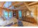 Warm main bedroom with a four-poster bed, wood walls and floors, and access to a private balcony at 169 Country Brooke Lane Ln, Roxboro, NC 27574