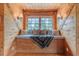 Relaxing window seat with wood-paneled walls, decorative pillows, and natural light at 169 Country Brooke Lane Ln, Roxboro, NC 27574