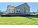 View of the backyard featuring a covered porch and sliding glass doors, offering a peaceful outdoor retreat at 17 Spring Crest Dr # 68, Angier, NC 27501