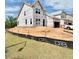 New two-story home featuring a garage, large windows, and situated on a lot during the construction phase at 17 Spring Crest Dr # 68, Angier, NC 27501
