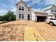 New two-story home featuring a garage, large windows, and situated on a lot during the construction phase at 17 Spring Crest Dr # 68, Angier, NC 27501