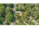 Aerial view of a cozy home with a long driveway and mature shade trees in a well-established neighborhood at 1800 Tarbert Dr, Cary, NC 27511