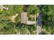 Overhead view capturing a cozy home featuring a long driveway and lush greenery bordering a quiet residential street at 1800 Tarbert Dr, Cary, NC 27511