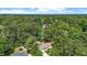 Lovely aerial view of a home nestled in a lush green forest setting with a trampoline in the backyard at 1800 Tarbert Dr, Cary, NC 27511