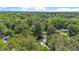 Aerial view showcasing a charming home surrounded by verdant trees and well-maintained lawns in a peaceful neighborhood at 1800 Tarbert Dr, Cary, NC 27511
