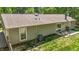 Serene backyard with a quaint patio setup, perfect for relaxing and enjoying the surrounding green landscape at 1800 Tarbert Dr, Cary, NC 27511