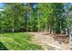 Spacious backyard featuring mature trees and partial fencing at 1800 Tarbert Dr, Cary, NC 27511