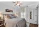Cozy bedroom with ceiling fan, large bed, and neutral-colored walls at 1800 Tarbert Dr, Cary, NC 27511