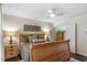 Well-lit bedroom featuring wooden furnishings and an open closet at 1800 Tarbert Dr, Cary, NC 27511