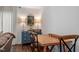 Bright dining area with a wood table, chairs, and a beautiful blue hutch with decor at 1800 Tarbert Dr, Cary, NC 27511
