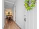Inviting entryway with hardwood floors, a view of the dining area, and a lemon wreath on the front door at 1800 Tarbert Dr, Cary, NC 27511