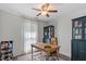 Cozy home office with a wooden desk, ceiling fan, and a patterned rug at 1800 Tarbert Dr, Cary, NC 27511