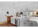 Bright kitchen featuring gray cabinets, stainless appliances, and seamless transition to the living area at 1800 Tarbert Dr, Cary, NC 27511