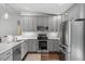 Modern kitchen featuring stainless steel appliances and gray cabinets at 1800 Tarbert Dr, Cary, NC 27511