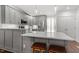 Modern gray kitchen boasts stainless appliances and a large center island with seating at 1800 Tarbert Dr, Cary, NC 27511