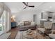 Open-concept living room with a modern sofa, stylish decor, and seamless access to the kitchen at 1800 Tarbert Dr, Cary, NC 27511