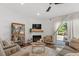 Bright living room with a fireplace, lots of natural light, and access to the back patio at 1800 Tarbert Dr, Cary, NC 27511