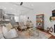 Open-concept living room flows into kitchen, featuring hardwood floors, stylish furnishings, and abundant natural light at 1800 Tarbert Dr, Cary, NC 27511