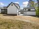 Rear view showcasing a screened in porch, detached garage, and covered walkway at 1903 Edgerton Dr, Durham, NC 27703