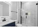 Modern bathroom with glass shower, white marble walls, and stylish navy vanity at 1903 Edgerton Dr, Durham, NC 27703