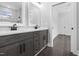 Modern bathroom with double vanity, marble countertops, dark wood cabinets, and a glass enclosed shower at 1903 Edgerton Dr, Durham, NC 27703