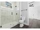 Modern bathroom featuring a glass-enclosed shower with marble tile and contemporary fixtures and wood look floors at 1903 Edgerton Dr, Durham, NC 27703
