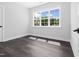 Bright bedroom with a large window providing natural light and wood look floors at 1903 Edgerton Dr, Durham, NC 27703