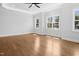 Bedroom boasts hardwood floors, recessed lighting, tray ceiling, and ample windows at 1903 Edgerton Dr, Durham, NC 27703