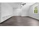 Bright bedroom featuring hardwood floors, a ceiling fan, and built-in shelves for storage and decor at 1903 Edgerton Dr, Durham, NC 27703