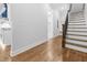 Entryway featuring hardwood floors, staircase with wrought iron spindles, and kitchen access at 1903 Edgerton Dr, Durham, NC 27703