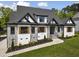 Charming home with stone accents, a well-manicured lawn, and lovely wooden window shutters at 1903 Edgerton Dr, Durham, NC 27703