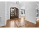 Welcoming foyer with decorative wood floors, view to dining room, and arched entryway at 1903 Edgerton Dr, Durham, NC 27703
