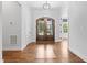 Grand foyer featuring hardwood floors and a striking front door with glass panels at 1903 Edgerton Dr, Durham, NC 27703
