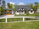 Beautiful new construction home featuring a manicured lawn, driveway, and black metal fence at 1903 Edgerton Dr, Durham, NC 27703