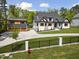 Stunning home featuring modern farmhouse design, landscaped lawn, and a detached three-car garage at 1903 Edgerton Dr, Durham, NC 27703
