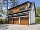 Oversized three-car garage, featuring stylish wood doors and a bonus living area above at 1903 Edgerton Dr, Durham, NC 27703