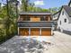 Spacious three-car garage with wood doors and an apartment above for added convenience at 1903 Edgerton Dr, Durham, NC 27703