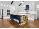 Gourmet kitchen featuring a center island with seating, stainless steel appliances, and wood floors at 1903 Edgerton Dr, Durham, NC 27703