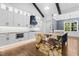 Kitchen with wood floors, white cabinets, stainless steel appliances, and a large island with a sink at 1903 Edgerton Dr, Durham, NC 27703