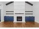 Living room with fireplace, wood mantle, custom built in cabinets and open floor plan at 1903 Edgerton Dr, Durham, NC 27703