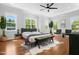 Staged main bedroom with sitting area, and large windows allowing for lots of natural light at 1903 Edgerton Dr, Durham, NC 27703