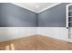 Office space featuring wainscoting, hardwood flooring, and a large window for ample light at 1903 Edgerton Dr, Durham, NC 27703