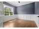 Office space featuring wainscoting, hardwood flooring, and a large window for ample light at 1903 Edgerton Dr, Durham, NC 27703