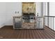 Outdoor kitchen featuring a built-in grill, stainless steel appliances, and stone accents at 1903 Edgerton Dr, Durham, NC 27703