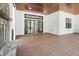Covered back patio featuring a stone fireplace, wood ceiling, and sliding glass doors at 1903 Edgerton Dr, Durham, NC 27703