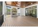 Covered outdoor patio with stone fireplace, wood ceiling, and ceiling fan at 1903 Edgerton Dr, Durham, NC 27703