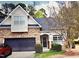 Charming home with stone accents, attached garage, and a well-maintained front lawn at 204 Plank Bridge Way, Morrisville, NC 27560