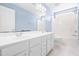 Bathroom boasts a double vanity with white cabinetry and a shower-tub combination at 210 Millet Dr, Morrisville, NC 27560